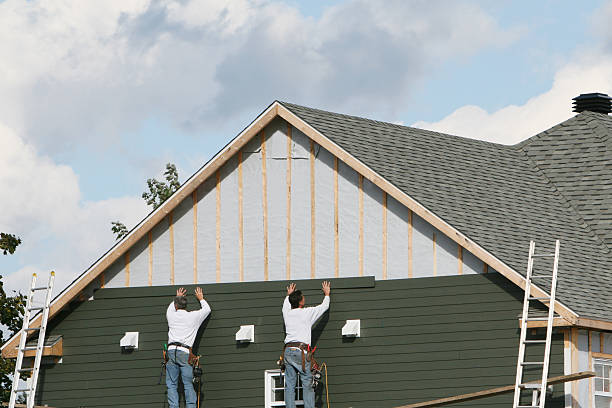 Professional Storm Damage Siding Repair technician working in Slickville, PA